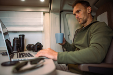 man working while travelling